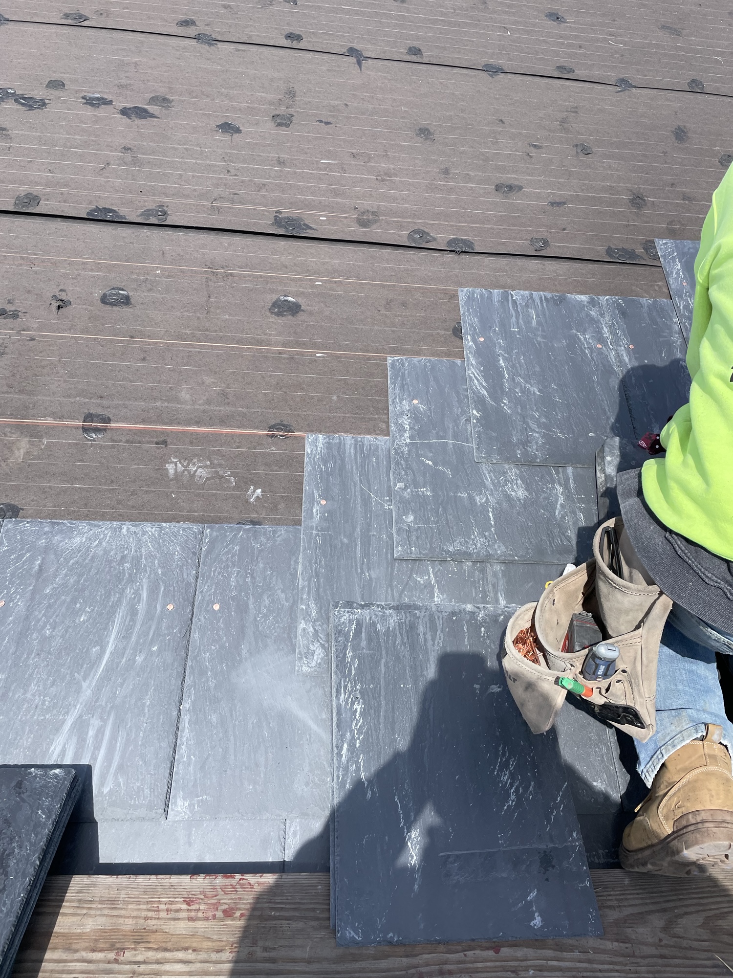 Close up view of new slate roof being installed