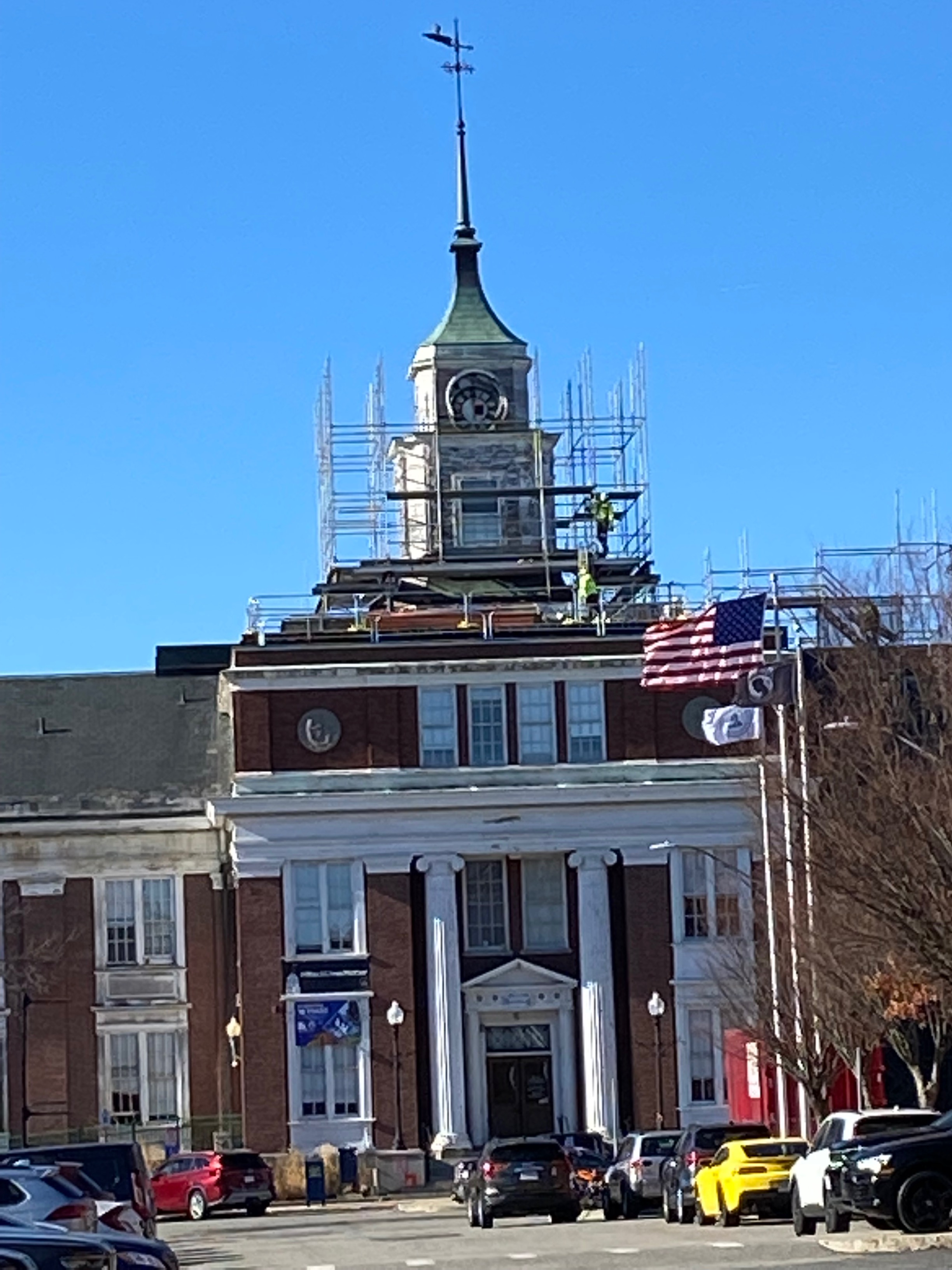 Somerville City Hall's clock tower surrounding by construction scaffolding