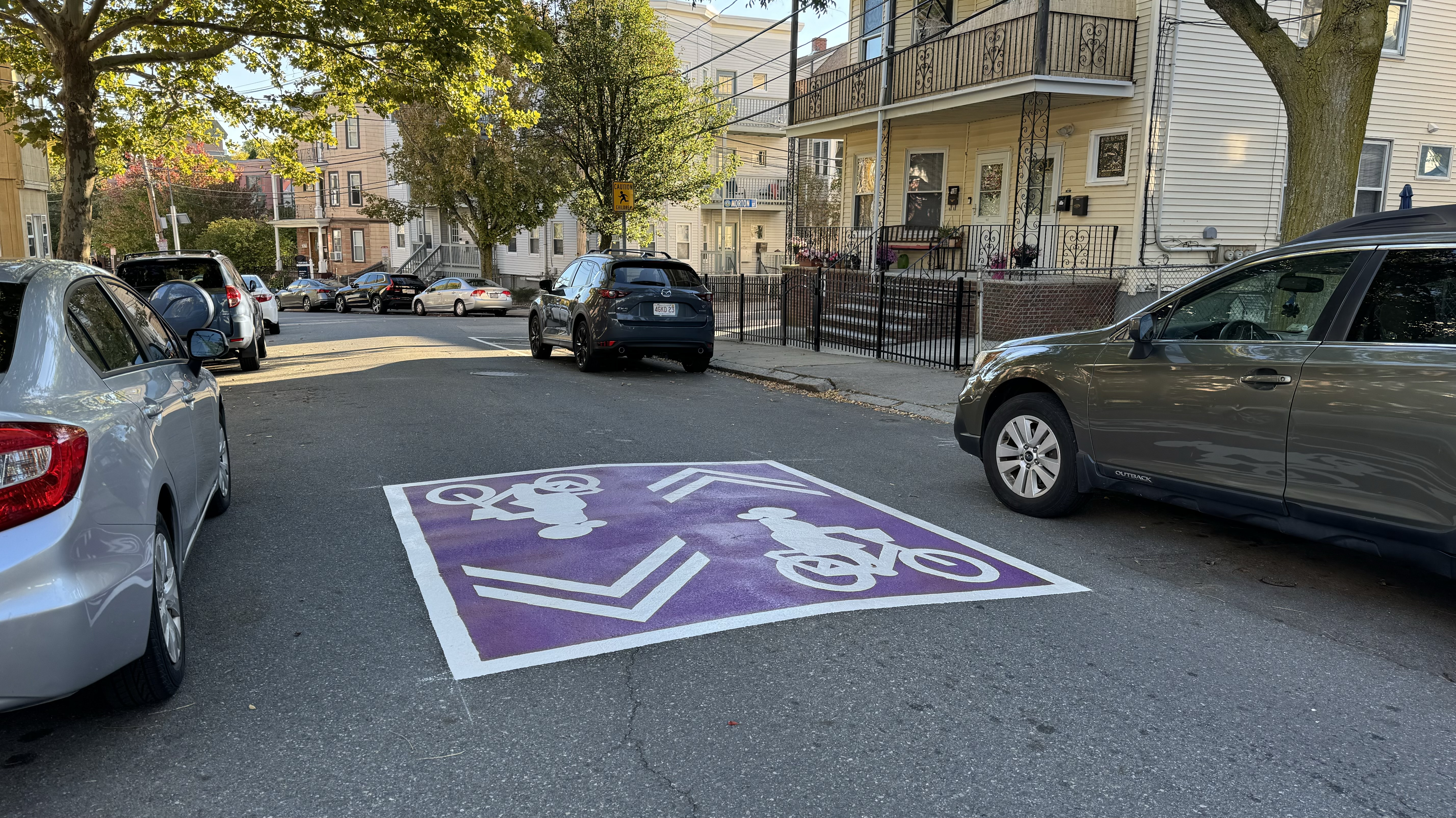 Large purple rectangle with a white image of a cyclist within. 