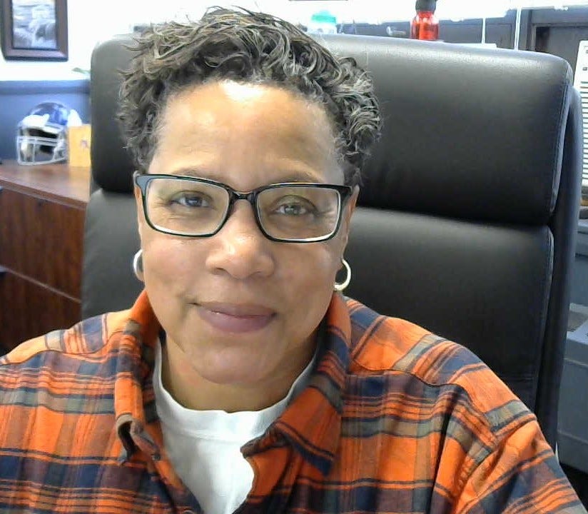 Photo of DPW Commissioner Jill Lathan, sitting in a chair at her desk