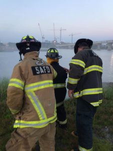 SAFD team members alongside the water during an incident. 