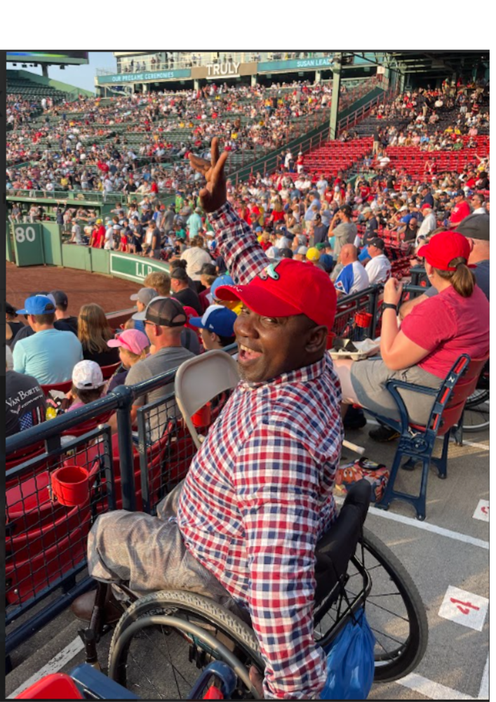 Smiling man in wheelchair at Red Sox Game