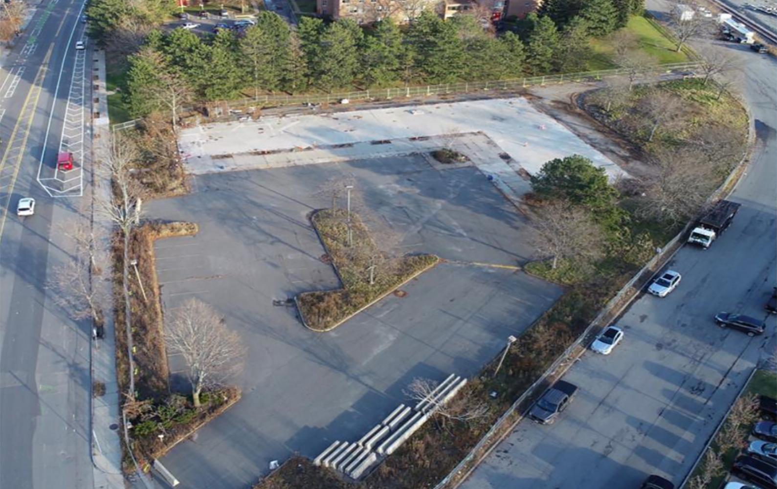 Aerial view of 90 Washington Street showing a large paved site bordered by Washington Street and surrounding buildings