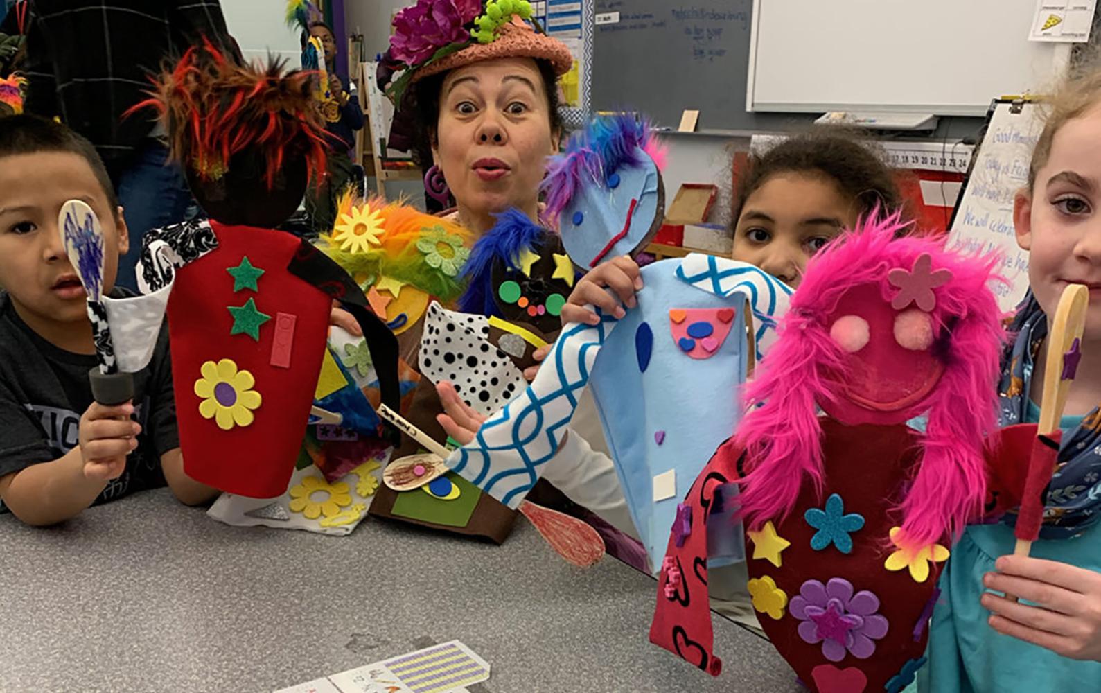 LCC grant recipient: Cozy Corner puppet and educational workshops with Faye Dupras holding up puppets they've made at the Healey School. 