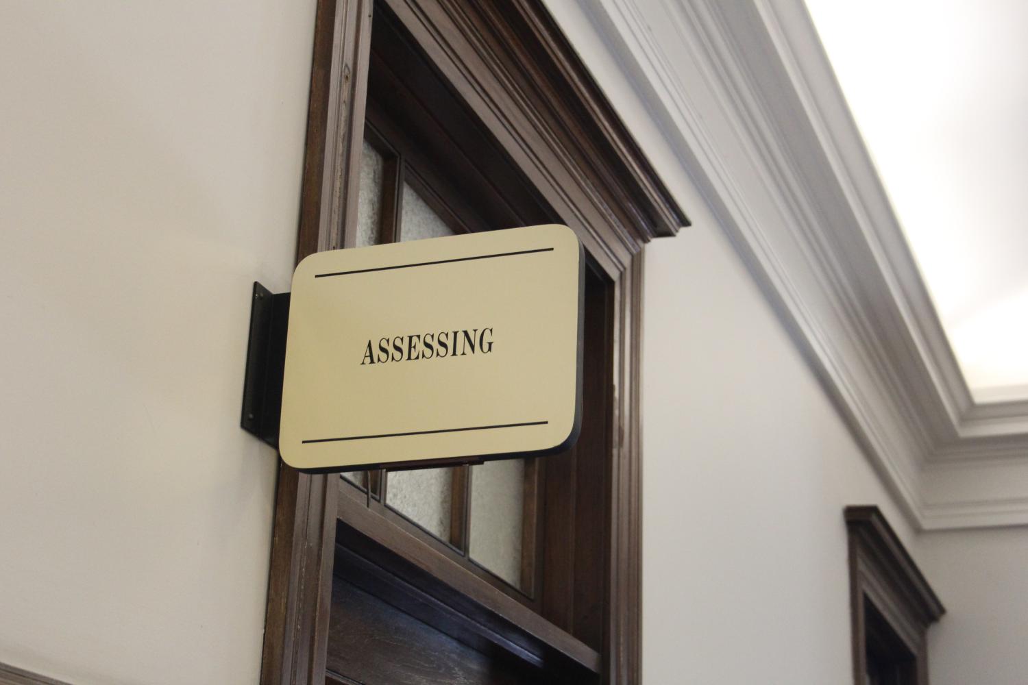 The sign above the Assessors Office in Somerville City Hall, black lettering on metallic backdrop.