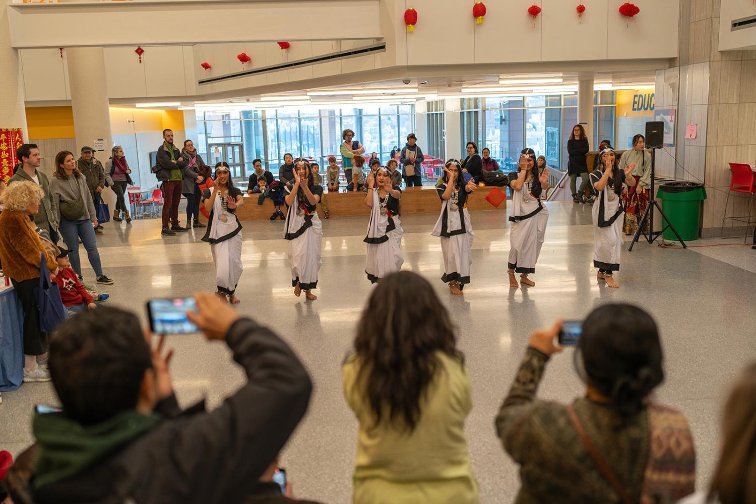 Dancers perform at a Somerville Lunar New Year celebration as an audience watches.