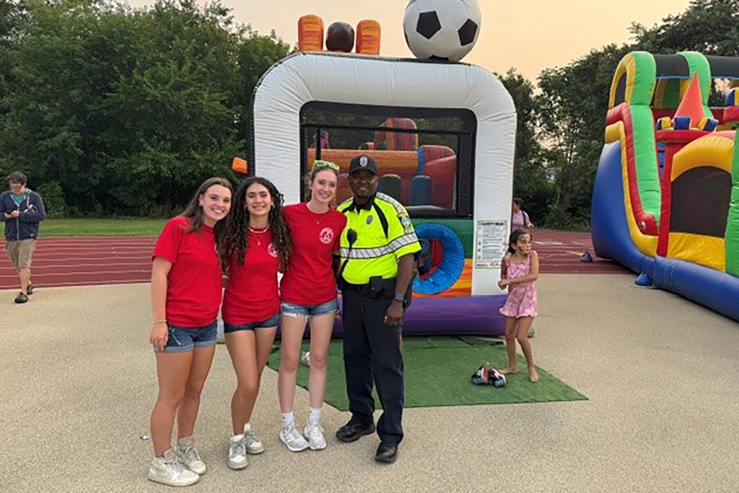 Community members and a police officer at the National Night Out event.