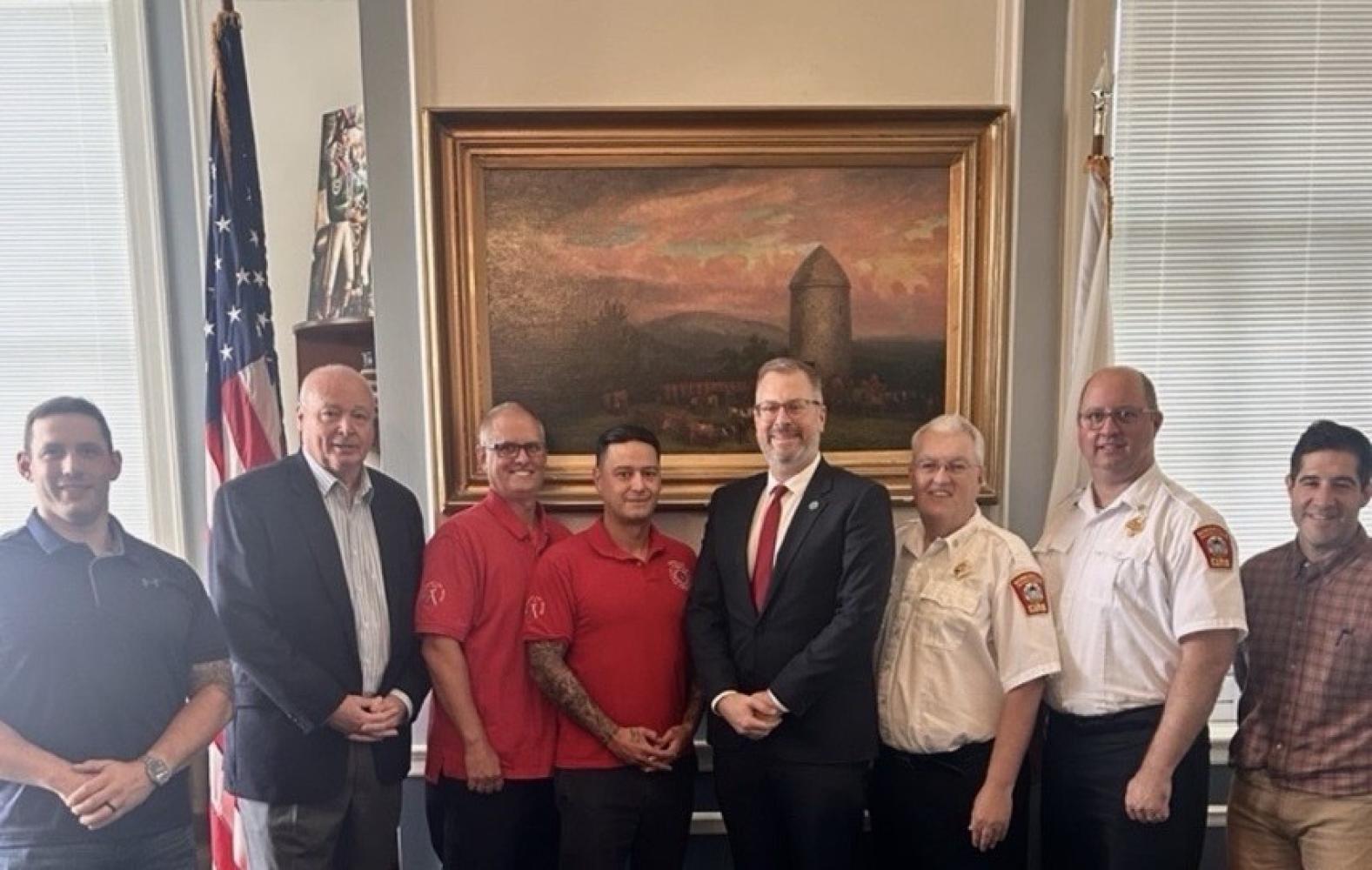 Mayor Jake Wilson with members of Firefighters Association Local 76  as they sign a three-year agreement. 