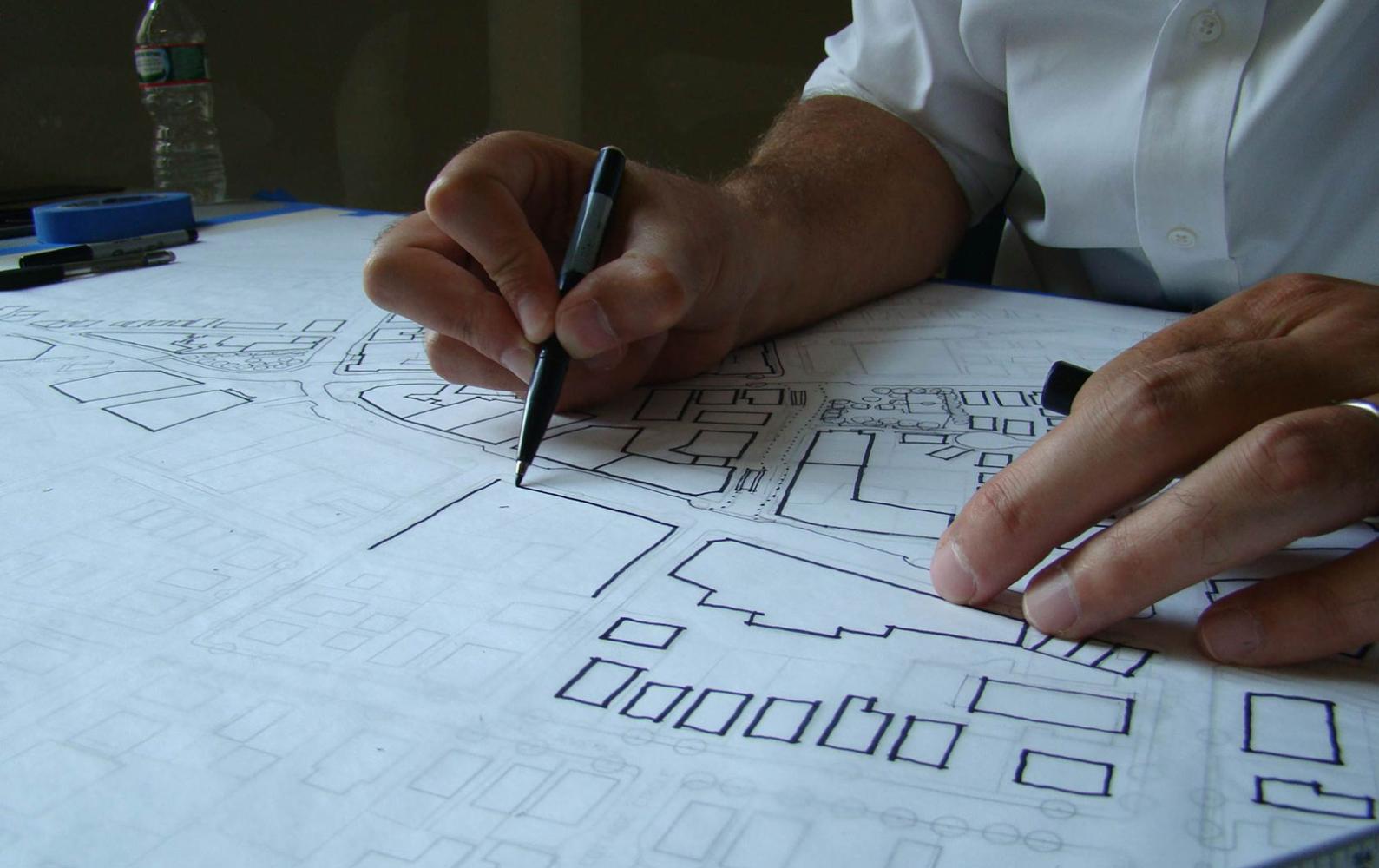 A City planner works on a sketch of a City neighborhood.