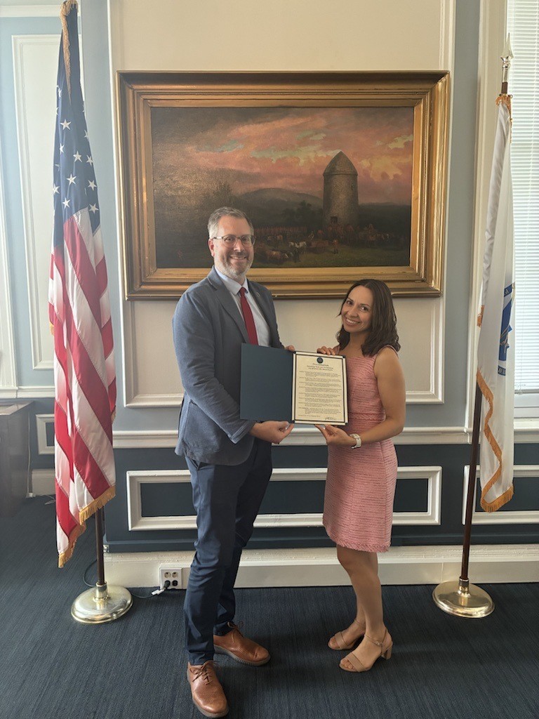 Mayor Jake Wilson stands with director of SomerViva Maria Nagle announcing the 2026 Welcoming Week proclamation. 