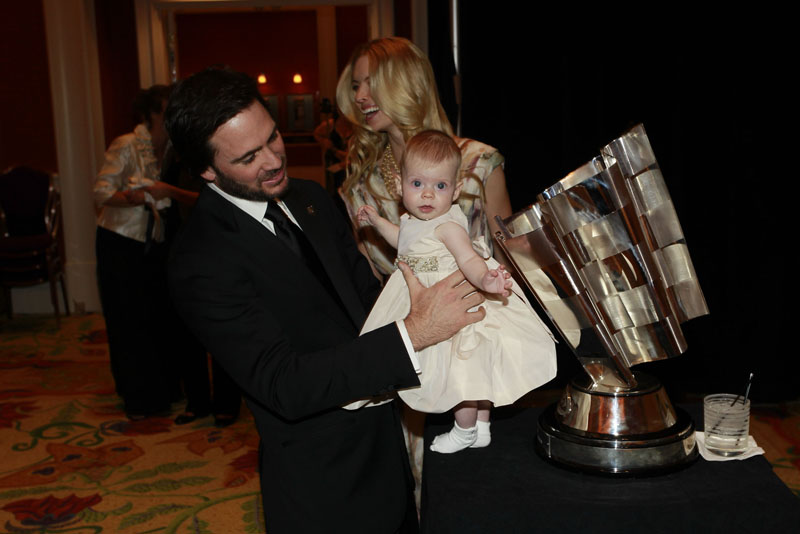 Jimmie Johnson baby FAMILY MAN: Jimmie Johnson holds his daughter Genevieve up next to his Sprint Cup trophy Friday night. (Chris Trotman/Getty Images Photo)