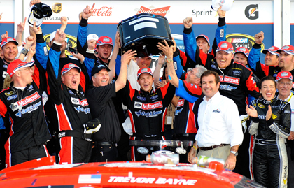 Daytona 500 Trevor Bayne hoists the Harley J. Earl Trophy in victory lane. (Jared C. Tilton/Getty Images Photo)