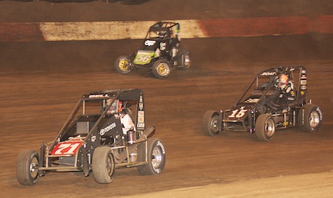 Christopher Bell (71) leads Darren Hagen (56) and Chad Boat during Thursday's Turkey Night Grand Prix. (Doug Allen photo)