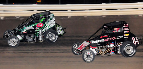 Bryan Clauson (63) battles Chad Boat during Saturday's Belleville Midget Nationals feature. Clauson was later seriously injured in a crash while leading the race. (Ken Simon Photo)