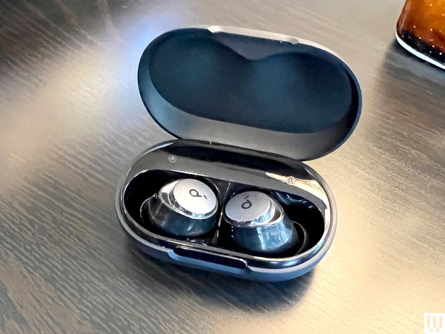 Open oval-shaped case with Anker Soundcore Space A40 wireless earbuds inside 