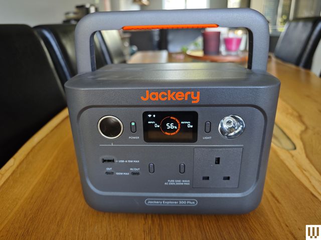 Jackery Explorer 300 Plus, a large grey square battery-shaped device with handle on top, outlets on the front face, and a small screen.