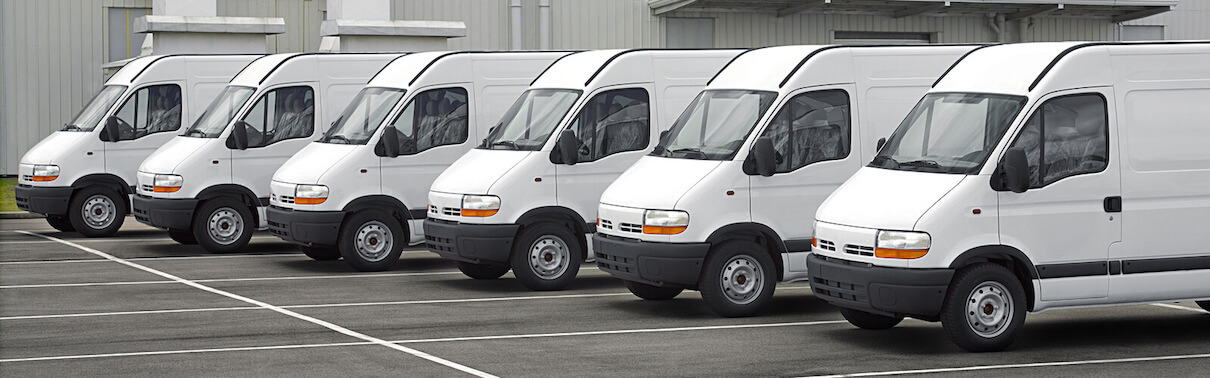 White vans lined up at depot