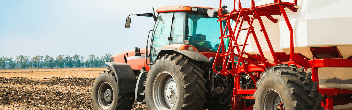 Tractor cutting crops in field