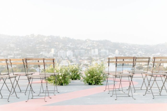 Photo of the city in the background with helipad and seating in foreground