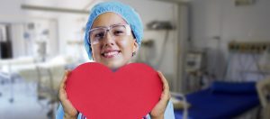 Photo of a nurse holding a large red heart