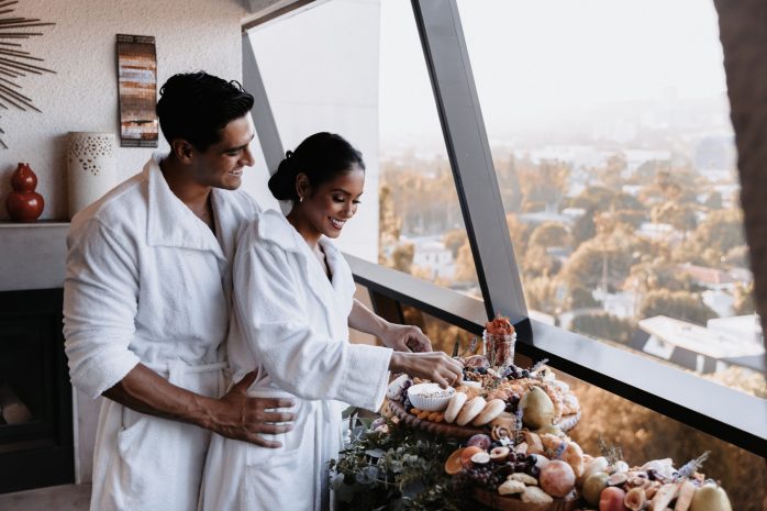 Photo of a couple in robes overlooking the city