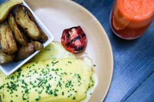 Photo of a plated breakfast omelette with juice