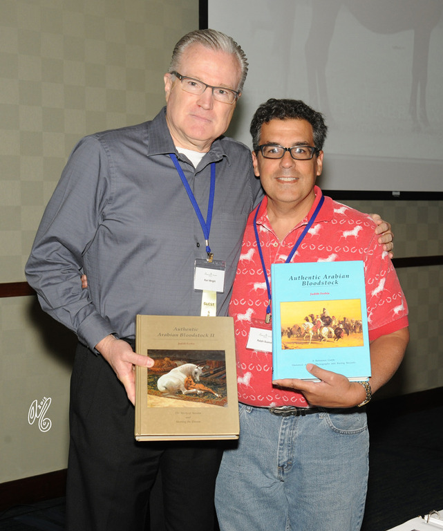 Keri Wright and Ralph Suarez with "The Gold" and "Blue" books, both by Judith Forbis