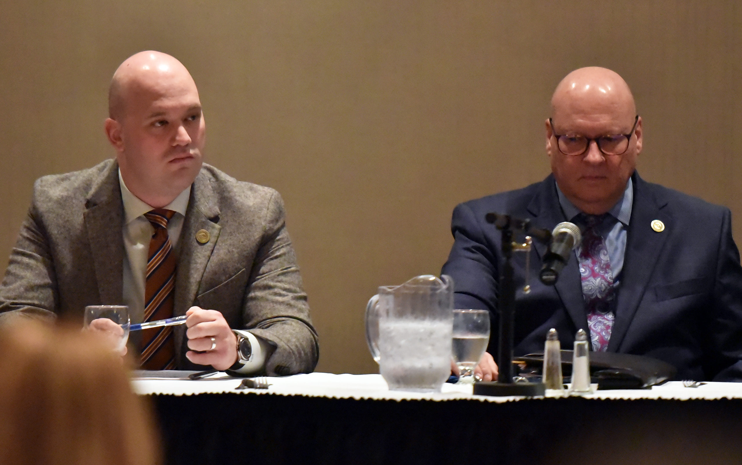 Commissioner Chairman Daniel Camp and Commissioner Jack Manning sitting for questions at the event.