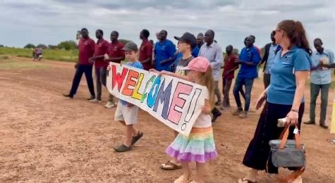 A group of people holding a sign