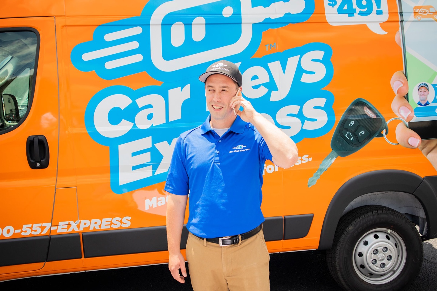 Car Keys Express technician holding a replacement key in front of a service van