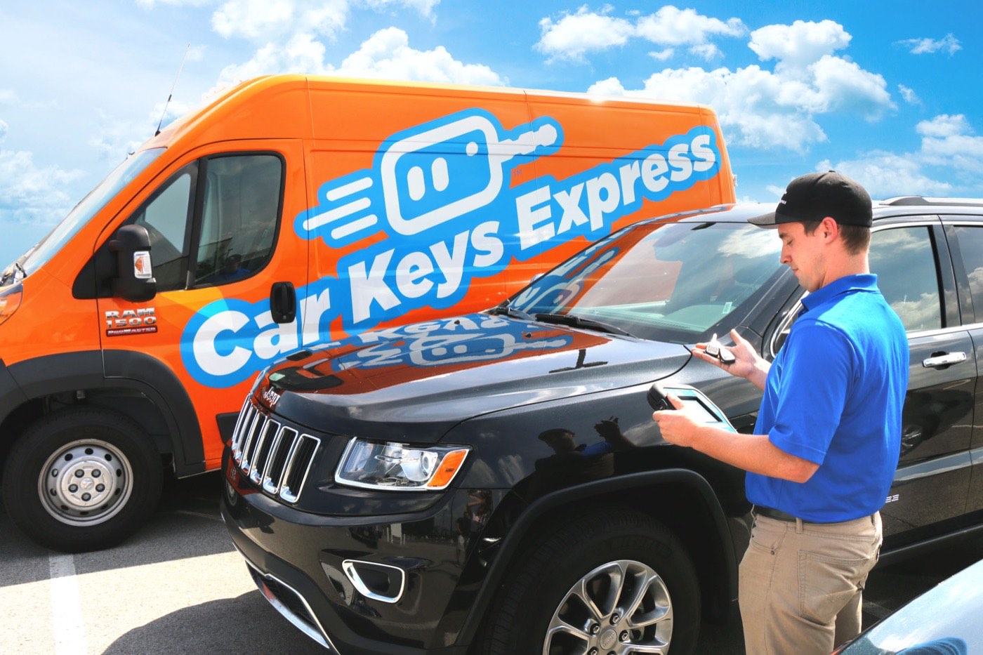 Car Keys Express technician helping a customer beside a service van