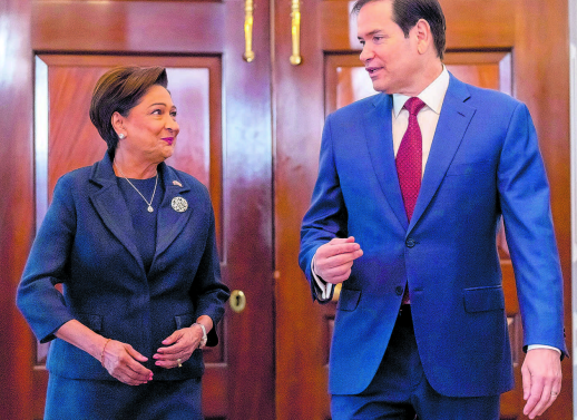 US Secretary of State Marco Rubio, right, chats with Prime Minister Kamla Persad-Bissessar at the State Department in Washington yesterday. AP PHOTO