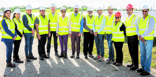 Ministers and others pose in front of a bank of solar panels at the Brechin Castle Solar Farm.