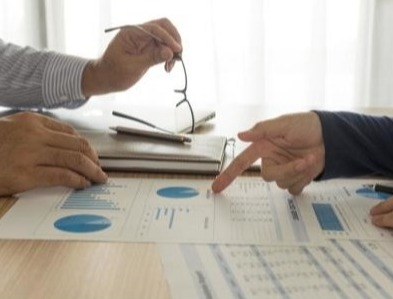 Looking over charts during a meeting