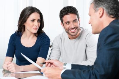 
Office Financial consultant reviews investments with a couple