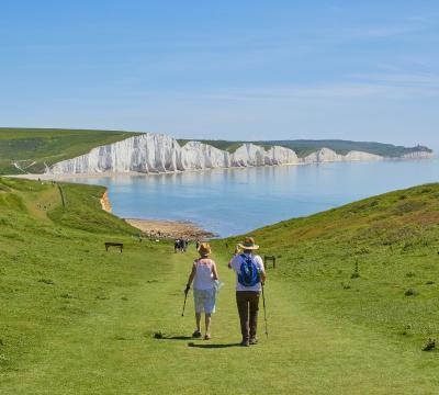 older couple hiking next to a lake