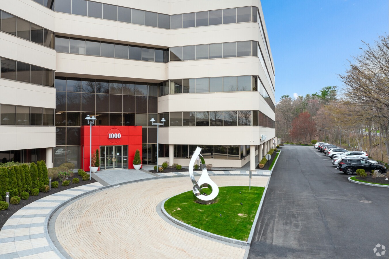 office building with modern sculpture in front of it