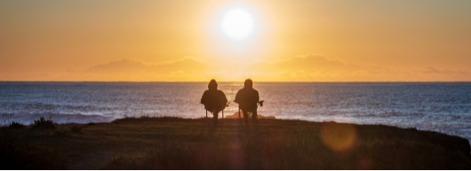 Couple-Sitting-on-Cliff