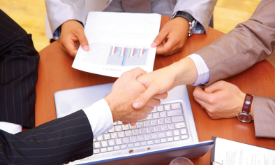 Handshake over laptop