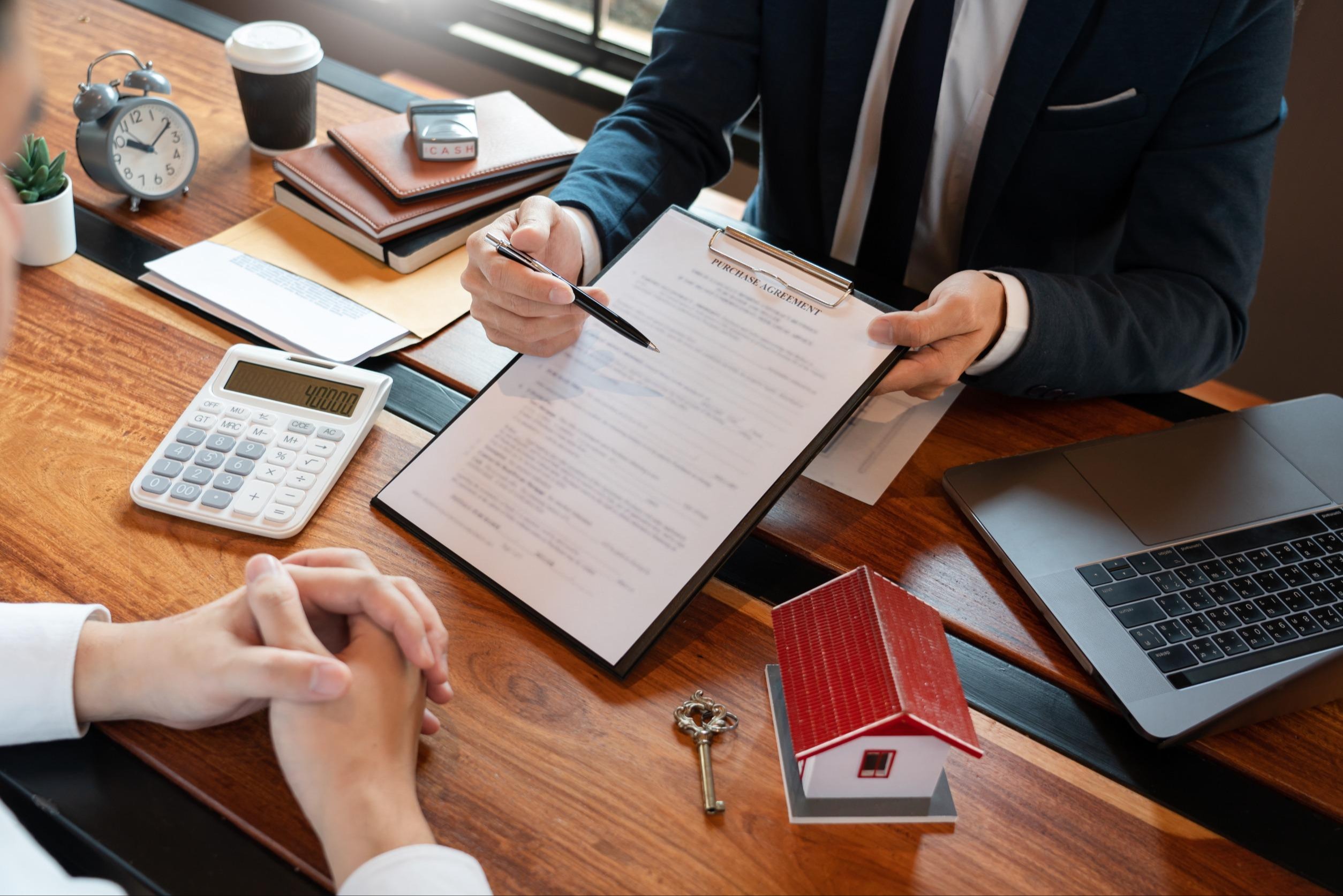 man in a suit explaining a document he is holding in front of him