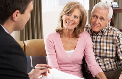 Older couple meeting with consultant