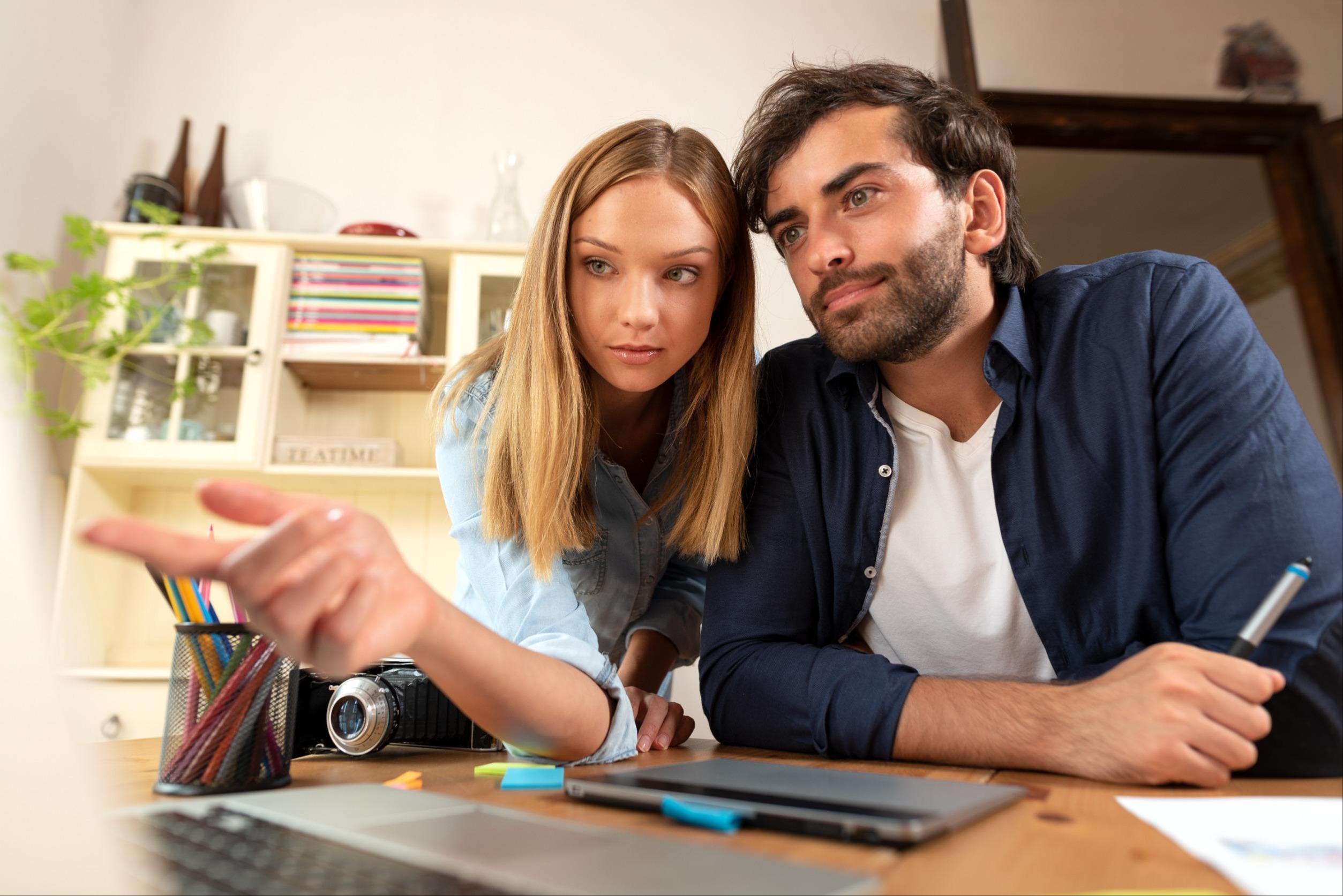 two people looking at a laptop