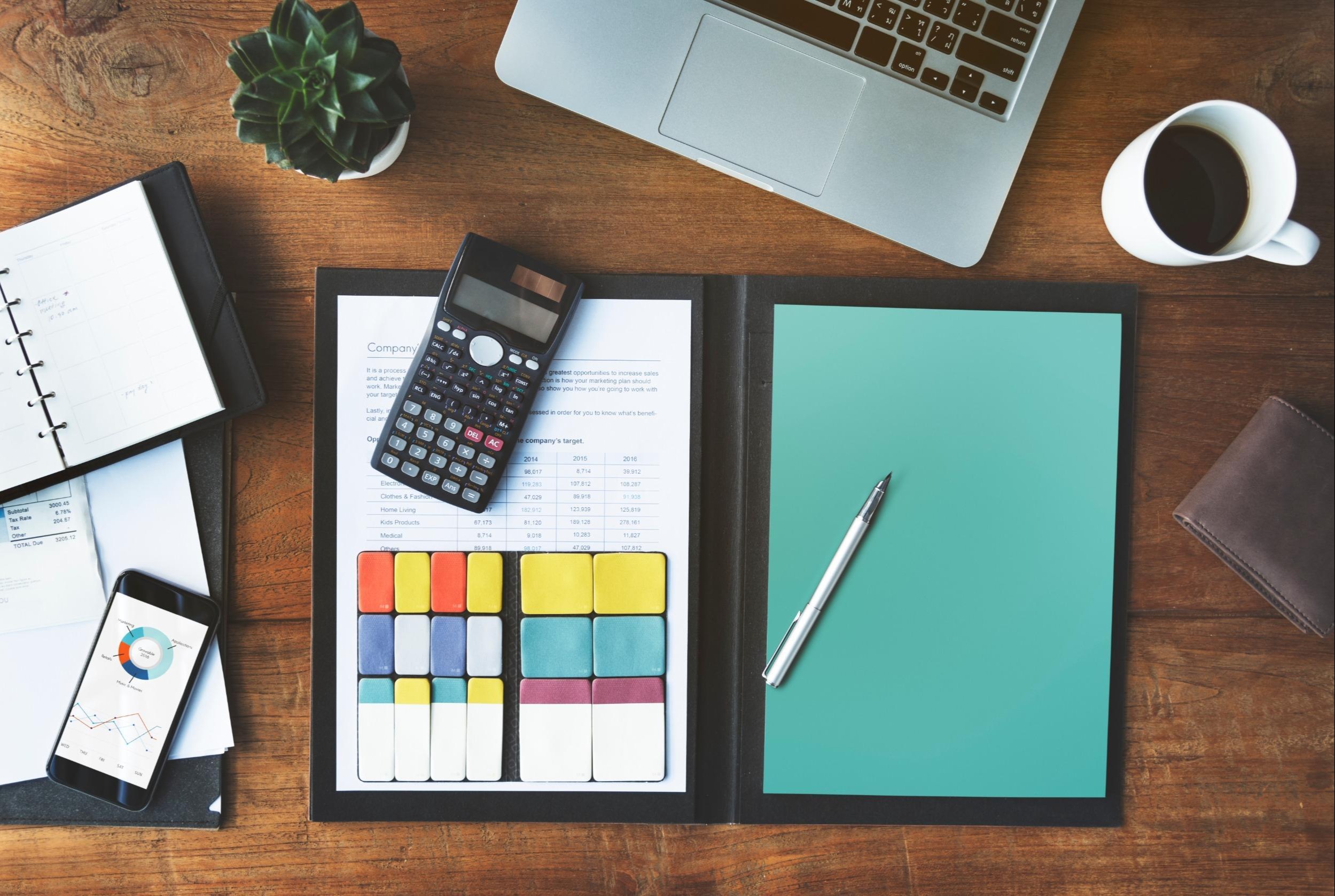 laptop, smartphone, day planner, calculator, cup of coffee