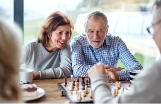 Man and woman playing chess at table