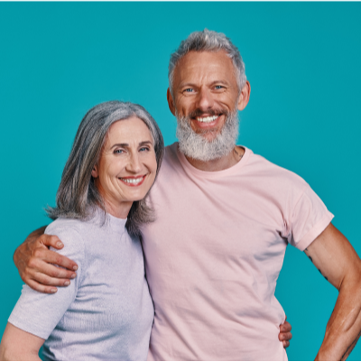 Man and woman hugging and smiling with a blue background