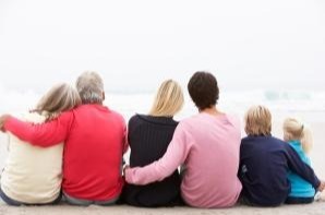 multi-generational family enjoying the ocean together