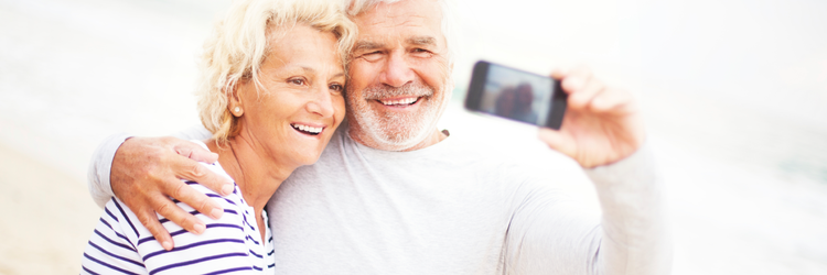 happy retired couple taking a selfie