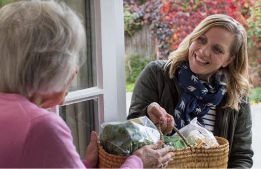 Woman handing over gift basket