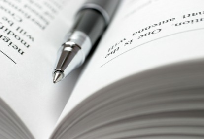 Close-up of a pen resting inside of a book