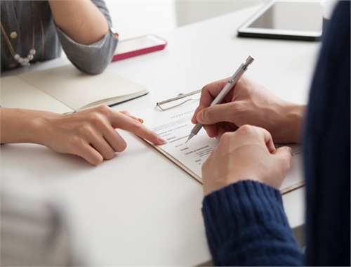 Financial advisor having client sign a contract of their financial plan